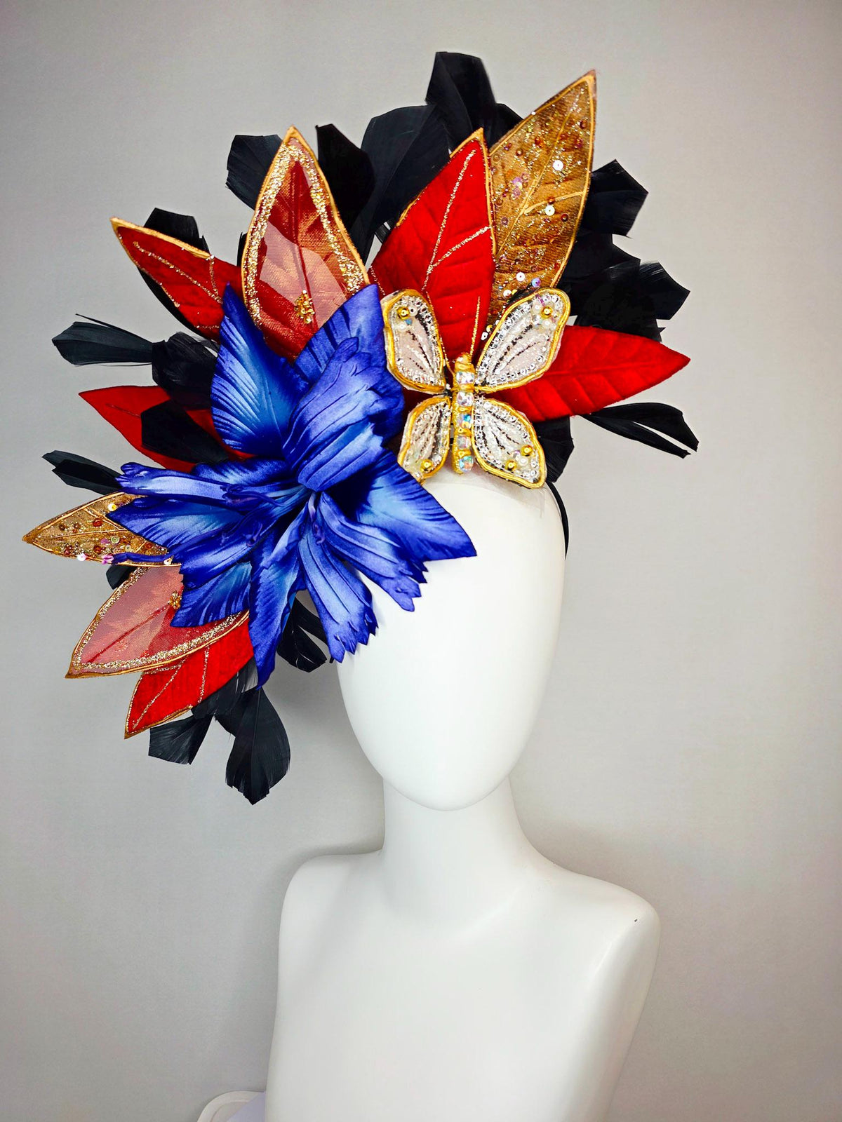 kentucky derby hat fascinator large royal blue satin flower red and gold organza satin leaves black branching feathers gold pearl butterfly