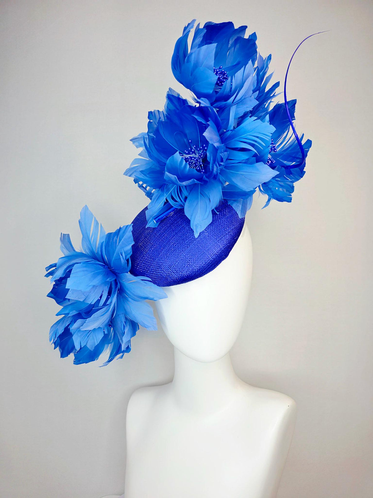 kentucky derby hat fascinator royal blue sinamay with large fluffy cobalt blue feather flowers and sky blue feathers